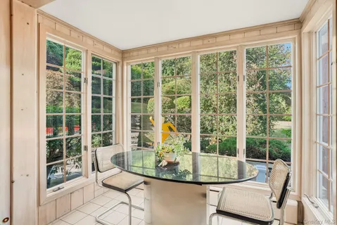a dining room with glass windows and glass windows