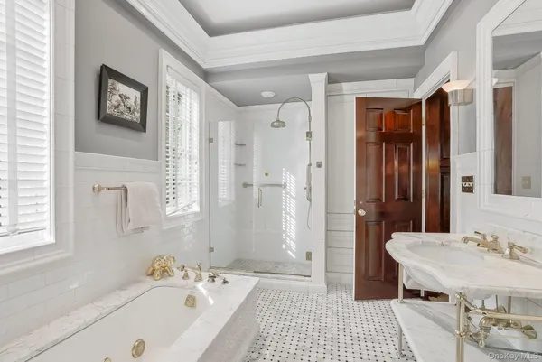 a bedroom with a bed and a dresser with mirror