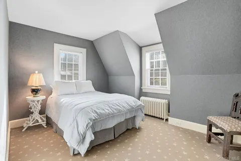 an aerial view of ocean and residential houses with outdoor space