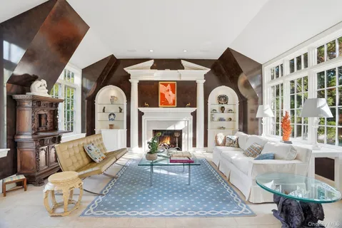 a living room with furniture a rug and a fireplace