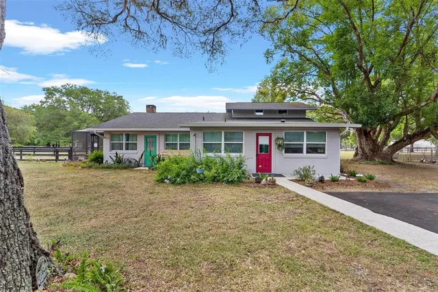 a view of living room with furniture and wooden floor