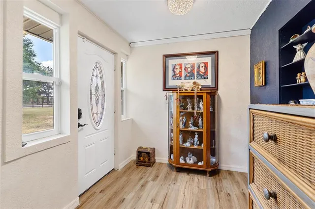 a view of a dining room with furniture wooden floor and chandelier