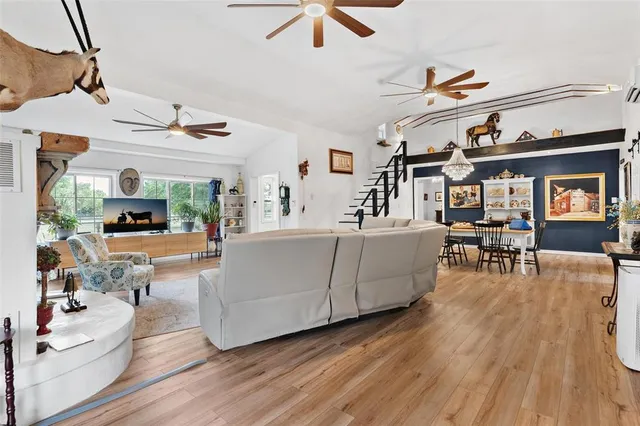 a kitchen with stainless steel appliances granite countertop a refrigerator a stove and a wooden floors