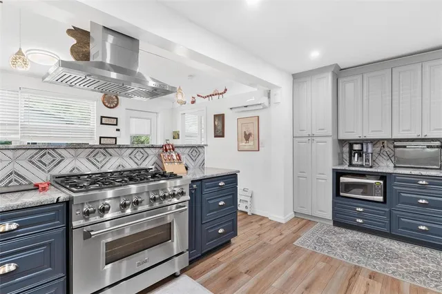 a spacious bedroom with a bed and a chandelier