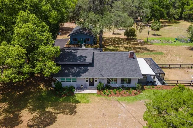 an aerial view of a house with swimming pool