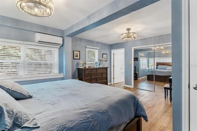 a bedroom with furniture and a chandelier