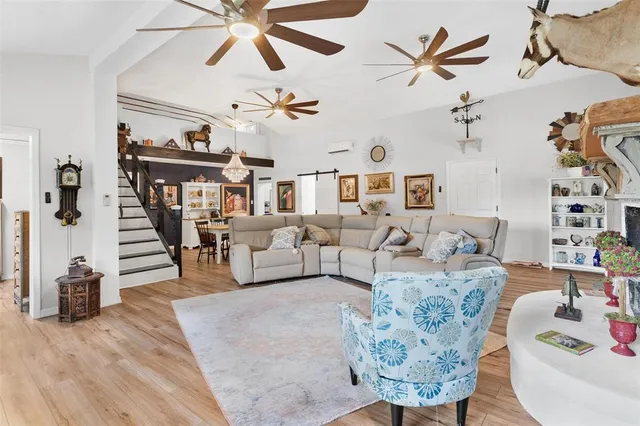 a living room with furniture and a chandelier