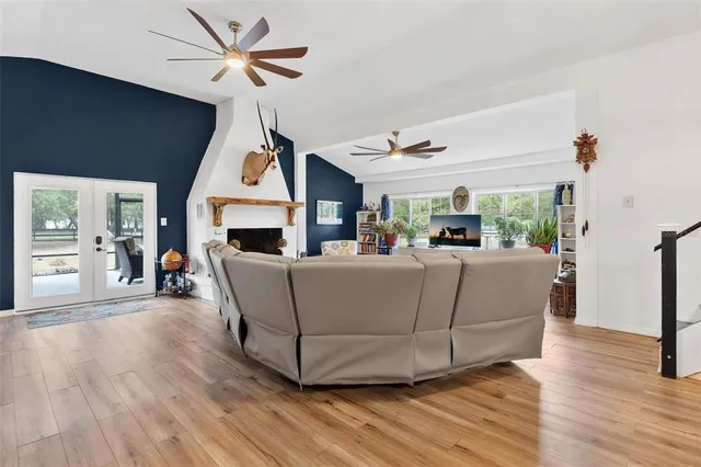 a view of backyard with large trees and a bench