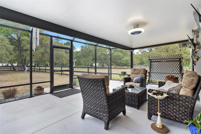 a view of a dining room with furniture a chandelier and wooden floor