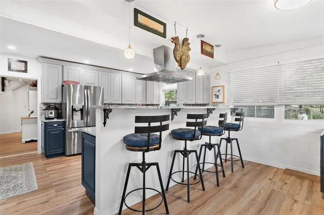 a living room with furniture a window and a flat screen tv