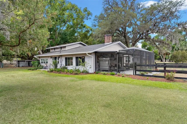 a view of a house with backyard and sitting area