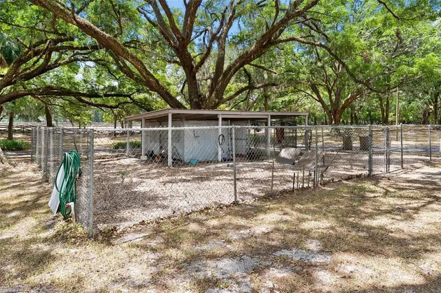 a front view of a house with garden and seating area