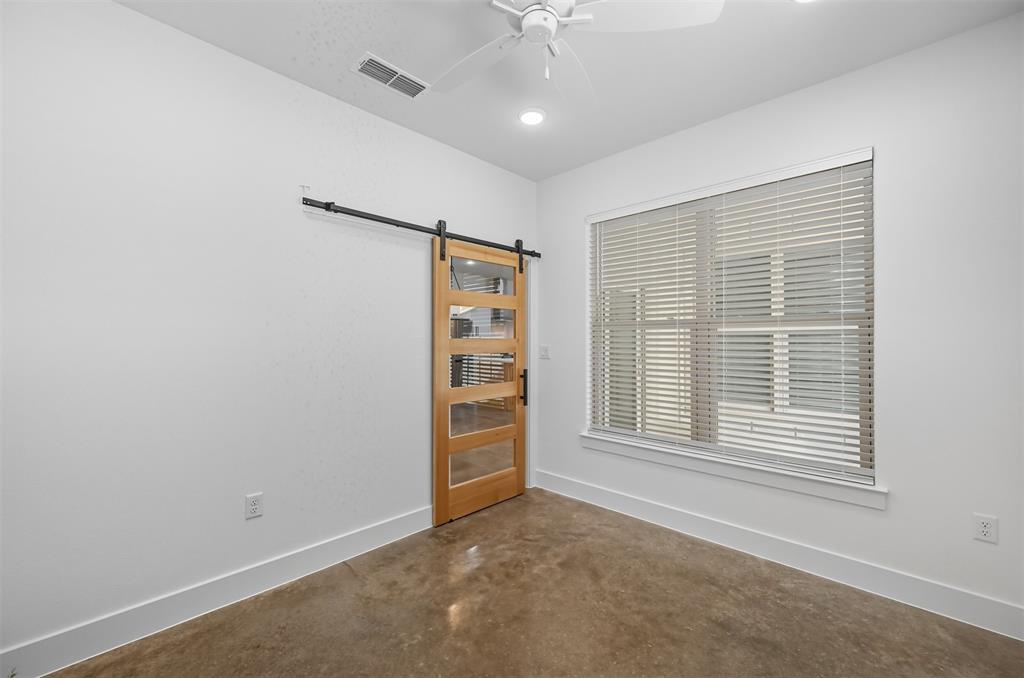102 Cardinal Wds Granbury, TX 76049 - Photo 20 of 36 Spare room with concrete floors, a barn door, ceiling fan, and recessed lighting