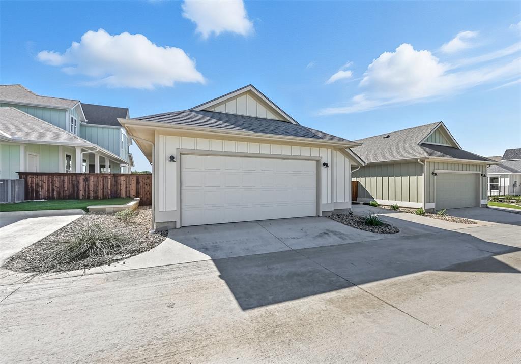 102 Cardinal Wds Granbury, TX 76049 - Photo 29 of 36 Garage featuring driveway