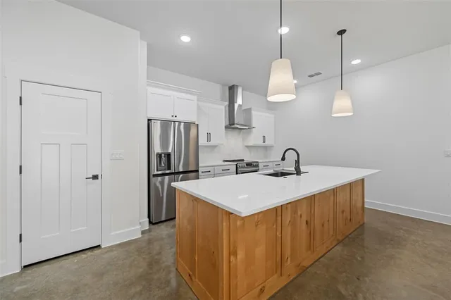 a kitchen with a sink a counter space appliances and cabinets