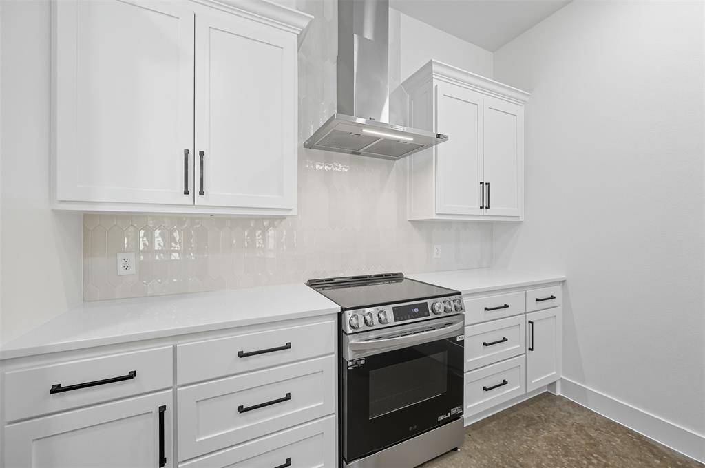 102 Cardinal Wds Granbury, TX 76049 - Photo 10 of 36 Kitchen with stainless steel electric range oven, white cabinets, wall chimney exhaust hood, tasteful backsplash, and light stone counters