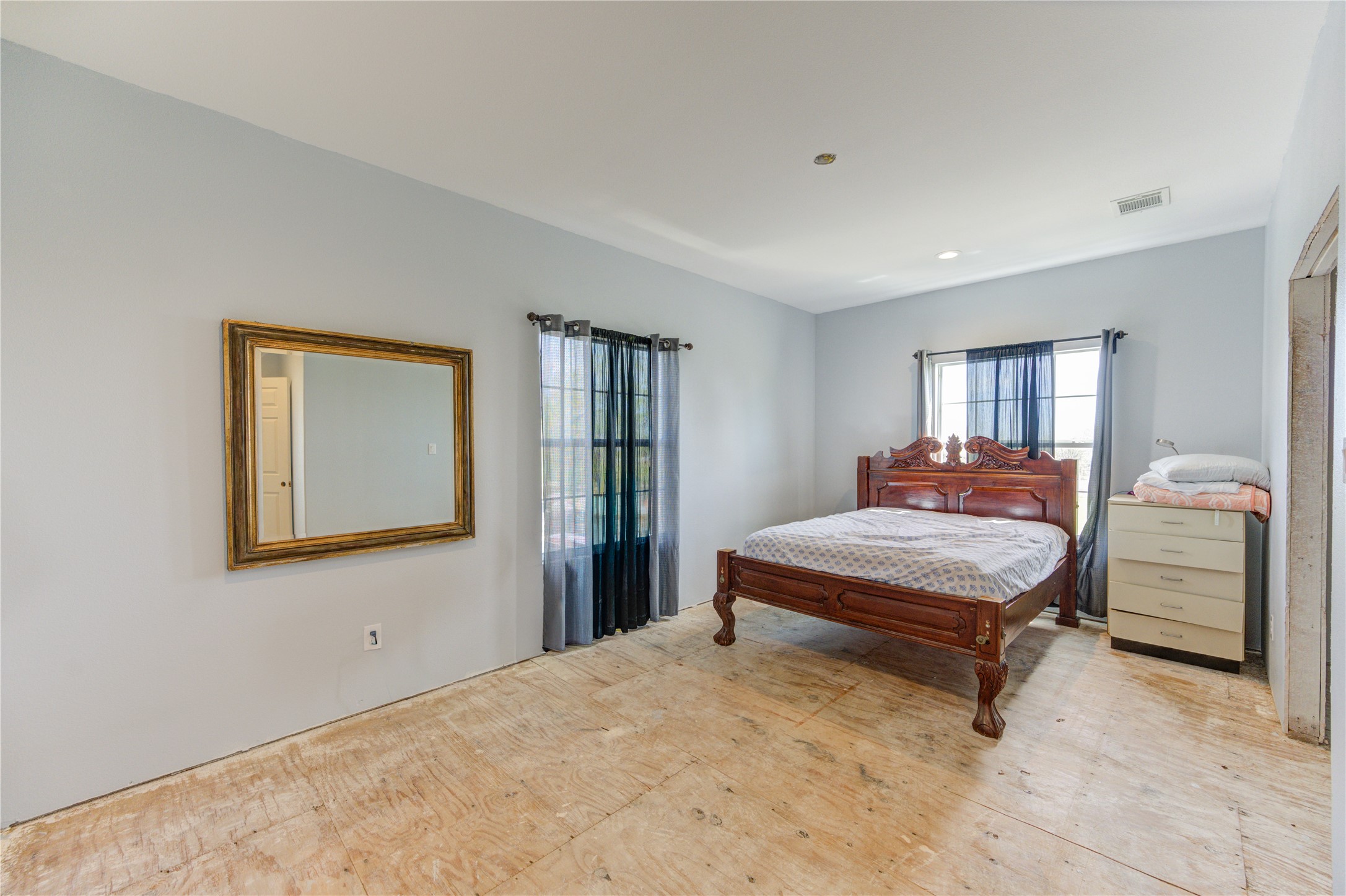 8570 Sunny Side Road Hempstead, TX 77445 - Photo 25 of 50 a bedroom with a bed and wooden floor