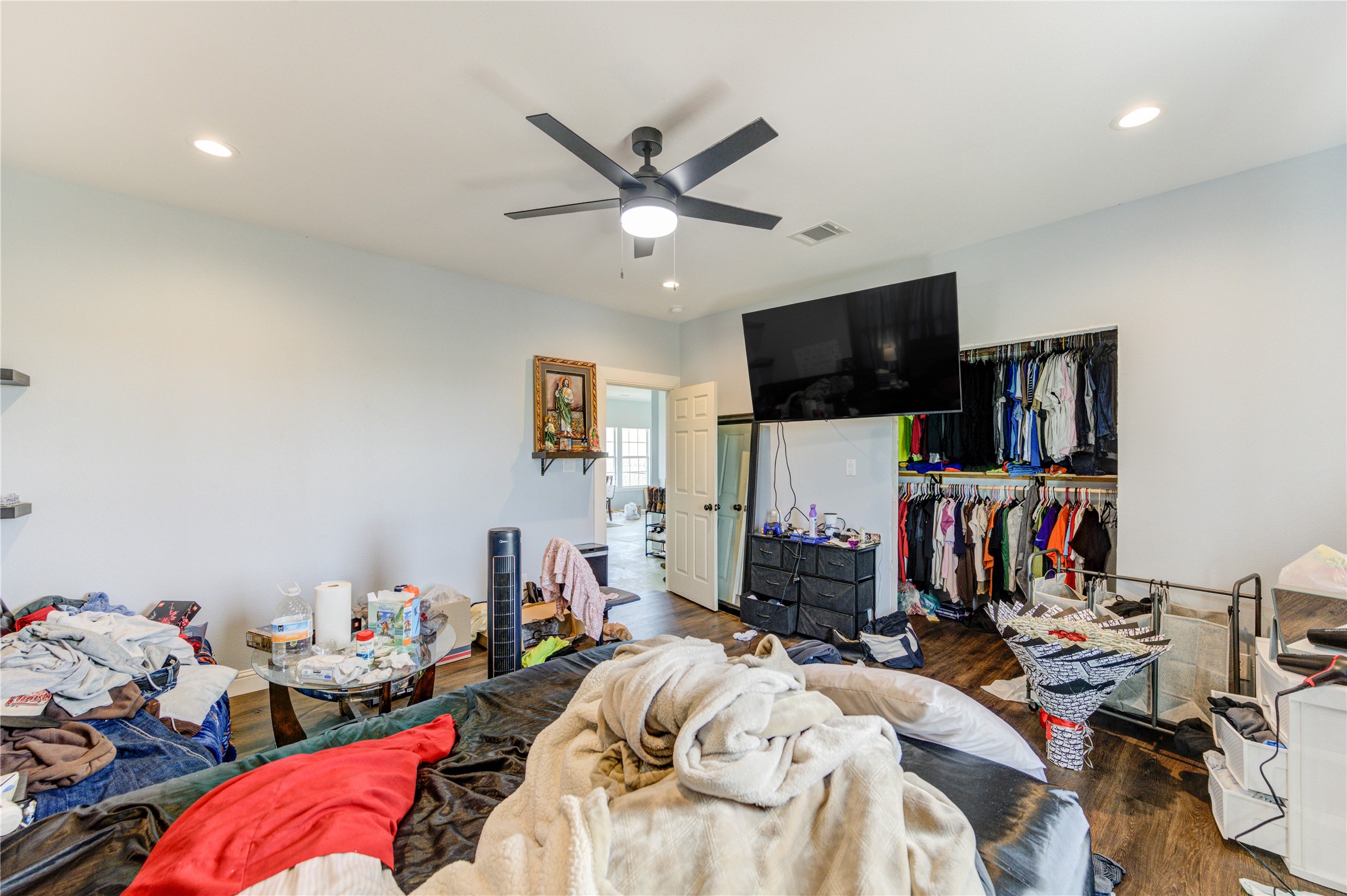 8570 Sunny Side Road Hempstead, TX 77445 - Photo 29 of 50 a bed room with a bed a flat screen tv and a ceiling fan