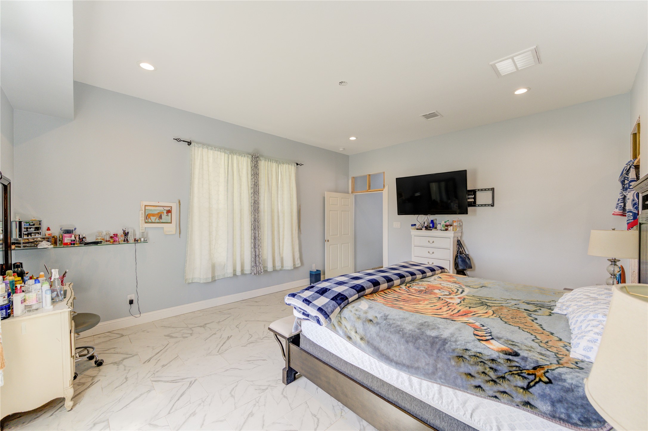 8570 Sunny Side Road Hempstead, TX 77445 - Photo 31 of 50 a bedroom with a bed and a flat screen tv