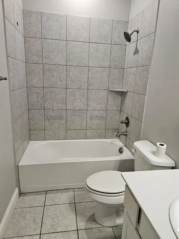 a bathroom with a toilet bathtub and shower