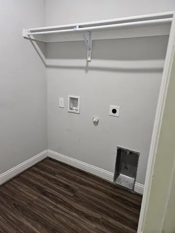 a view of a room with wooden floor