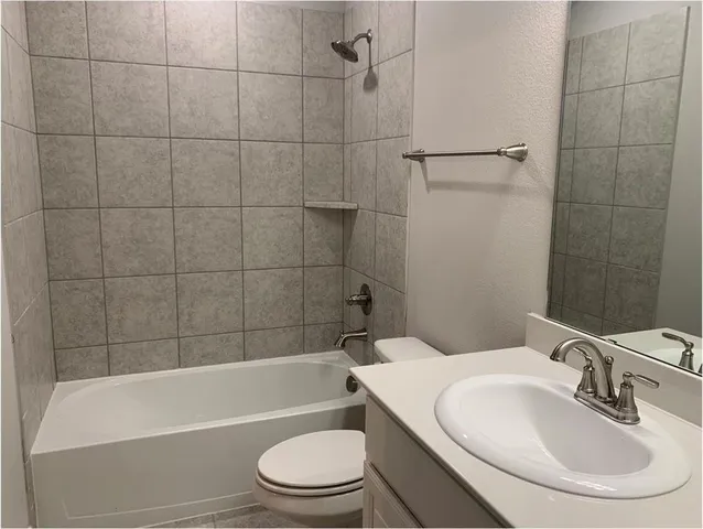 a bathroom with a toilet a sink and bathtub