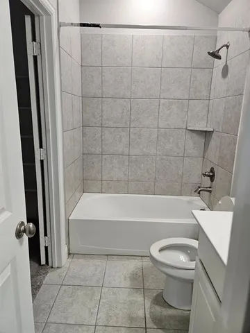 a bathroom with a bathtub a toilet and a shower