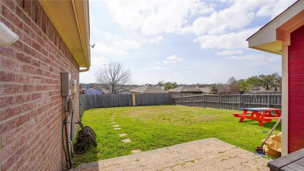 a view of a house with a yard and sitting area