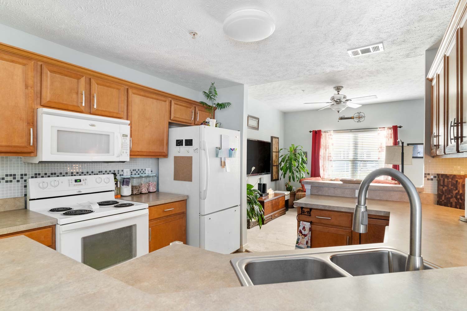 2018 Arum Court Spring Hill, TN 37174 - Photo 11 of 38 a kitchen with stainless steel appliances kitchen island granite countertop a sink and a refrigerator