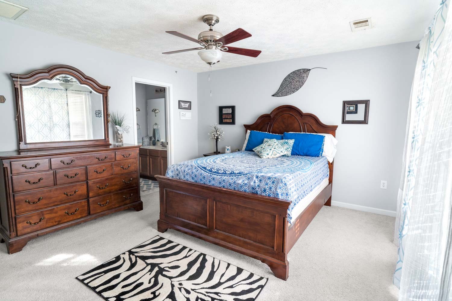 2018 Arum Court Spring Hill, TN 37174 - Photo 22 of 38 a bedroom with a bed and dresser with mirror