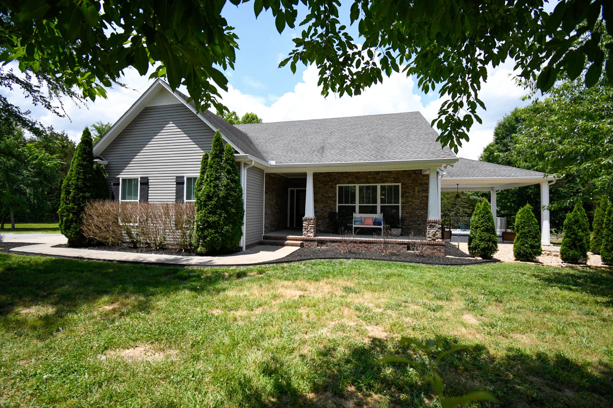 a view of a house with a yard and sitting area