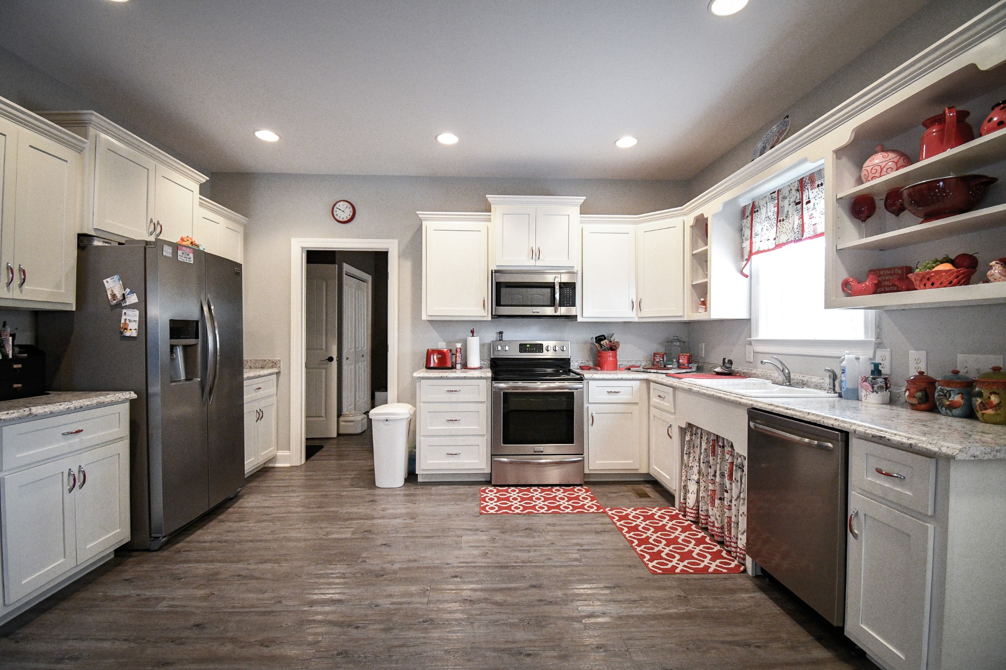 2848 Carpenter Bridge Road Columbia, TN 38401 - Photo 30 of 46 a kitchen with stainless steel appliances kitchen island granite countertop a refrigerator oven a sink dishwasher and white cabinets with wooden floor