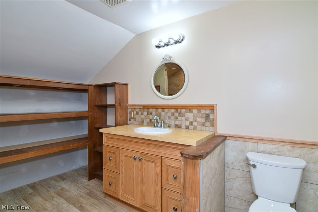 7251 Ryan Road Medina, OH 44256 - Photo 19 of 47 2nd level Bathroom vanity featuring wood-finish cabinetry, a white basin sink, and a light-toned countertop