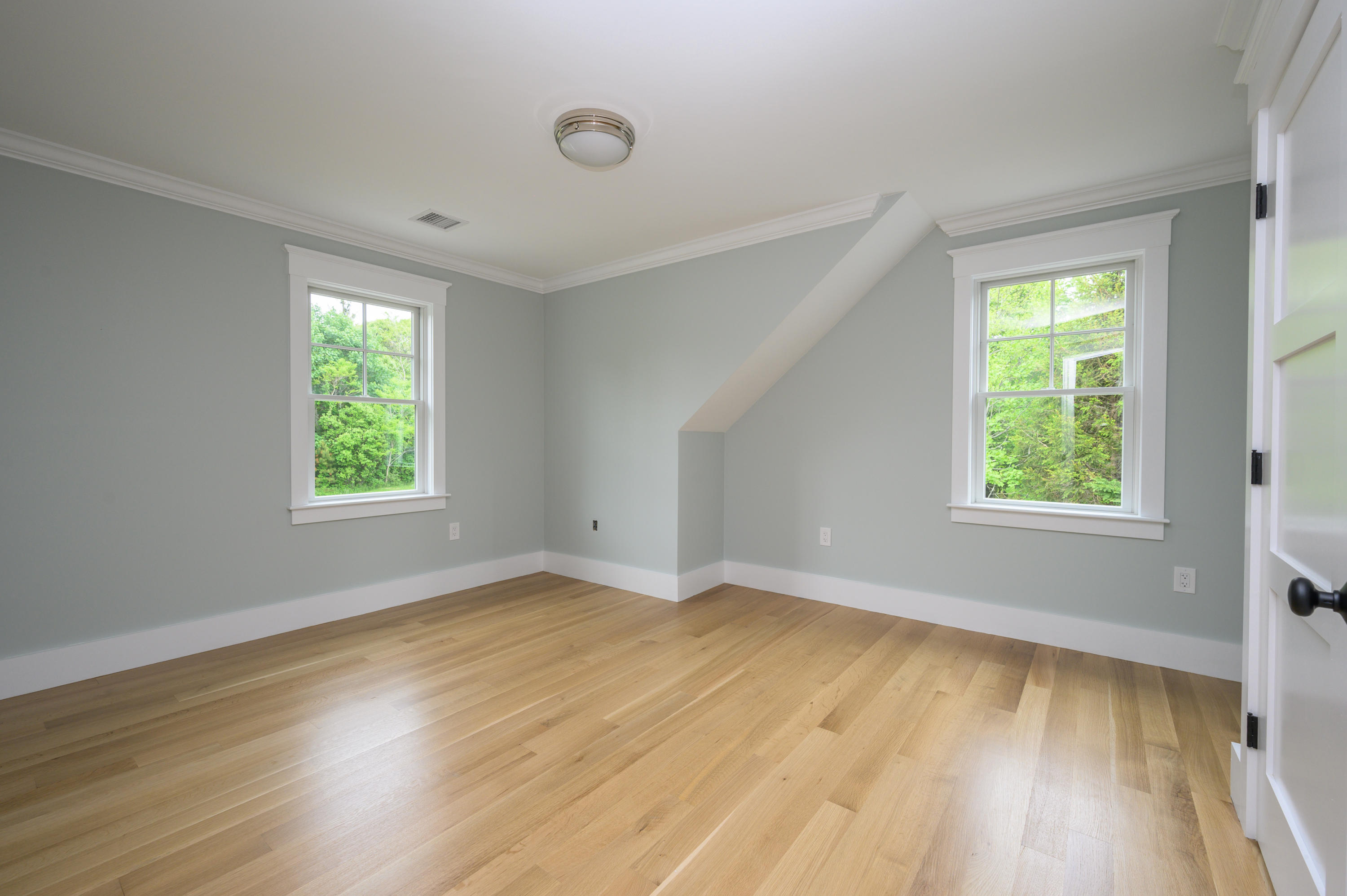 164 Breakwater Road Brewster, MA 02631 - Photo 32 of 57 a view of an empty room with wooden floor and a window