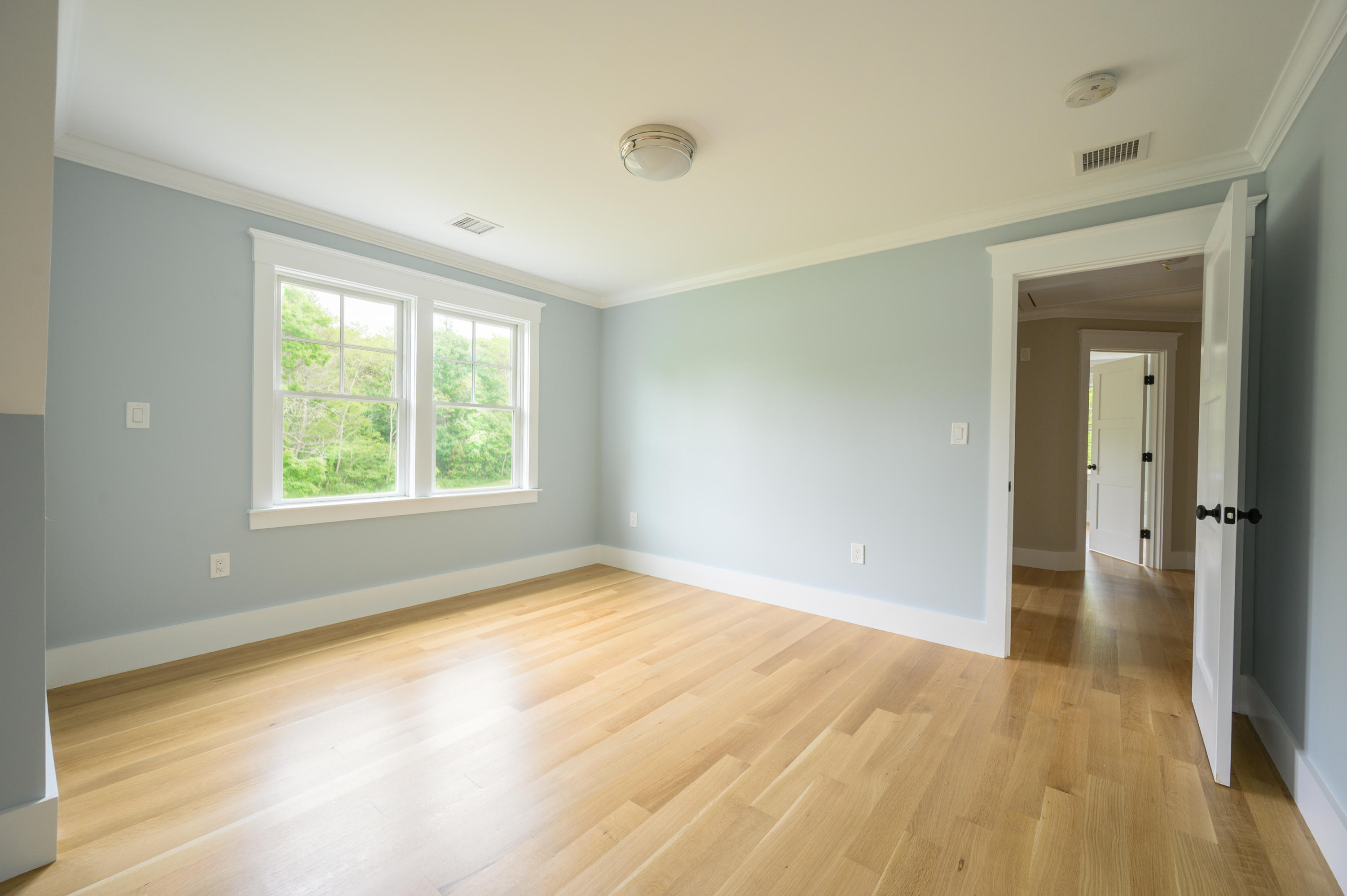 164 Breakwater Road Brewster, MA 02631 - Photo 35 of 57 an empty room with wooden floor and windows