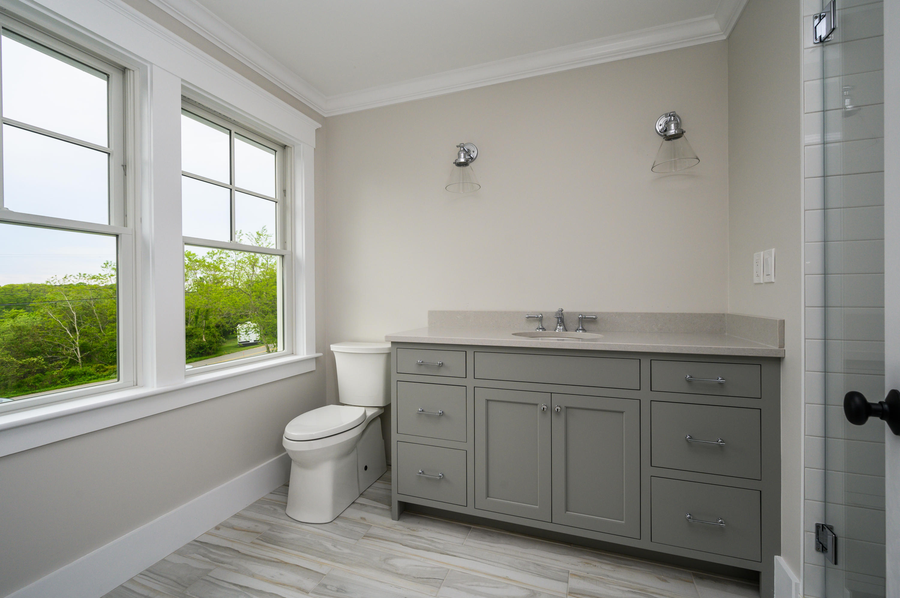 164 Breakwater Road Brewster, MA 02631 - Photo 40 of 57 a bathroom with a granite countertop toilet a sink and a window