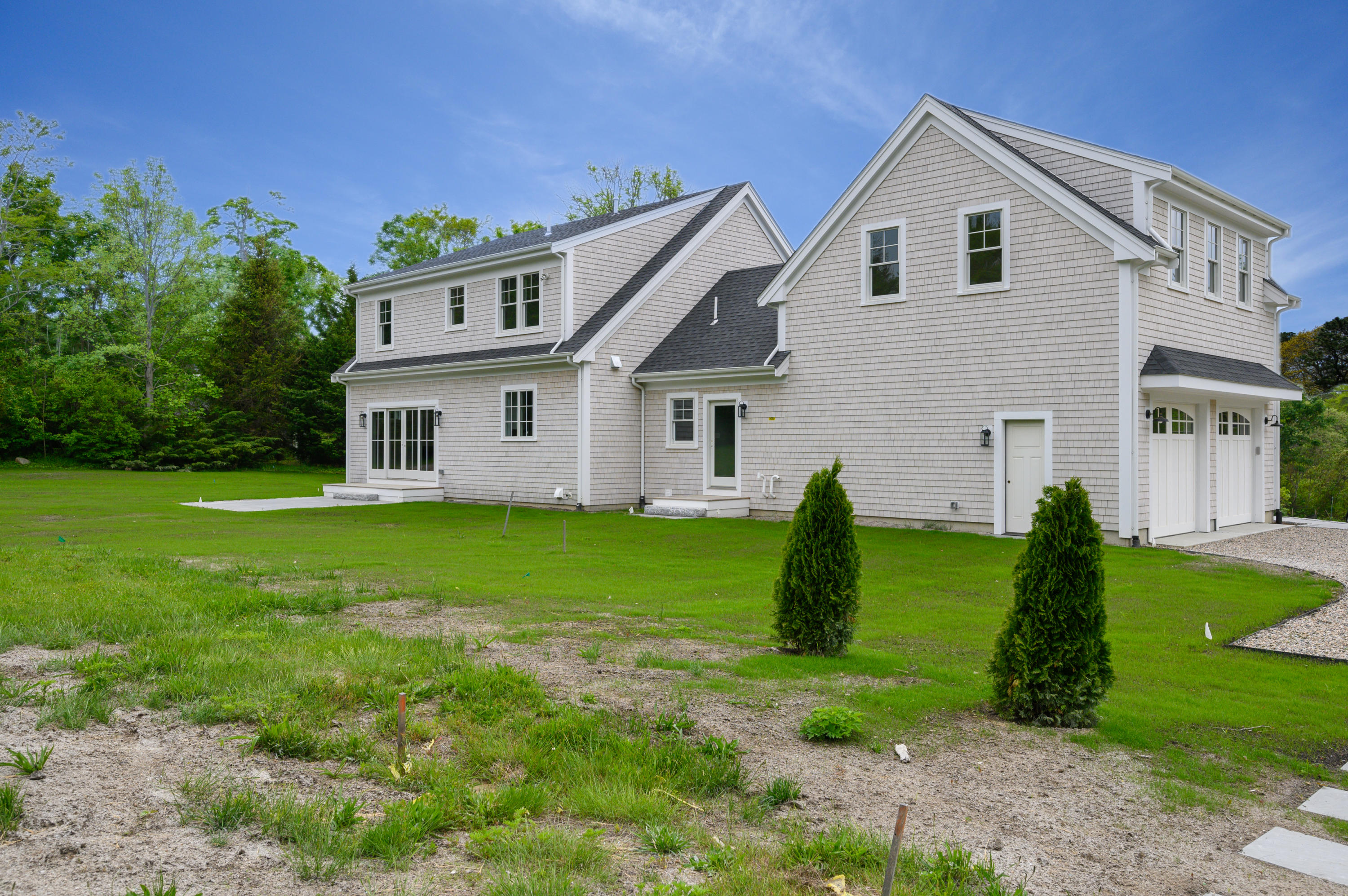 164 Breakwater Road Brewster, MA 02631 - Photo 43 of 57 a view of a white house with a big yard and potted plants