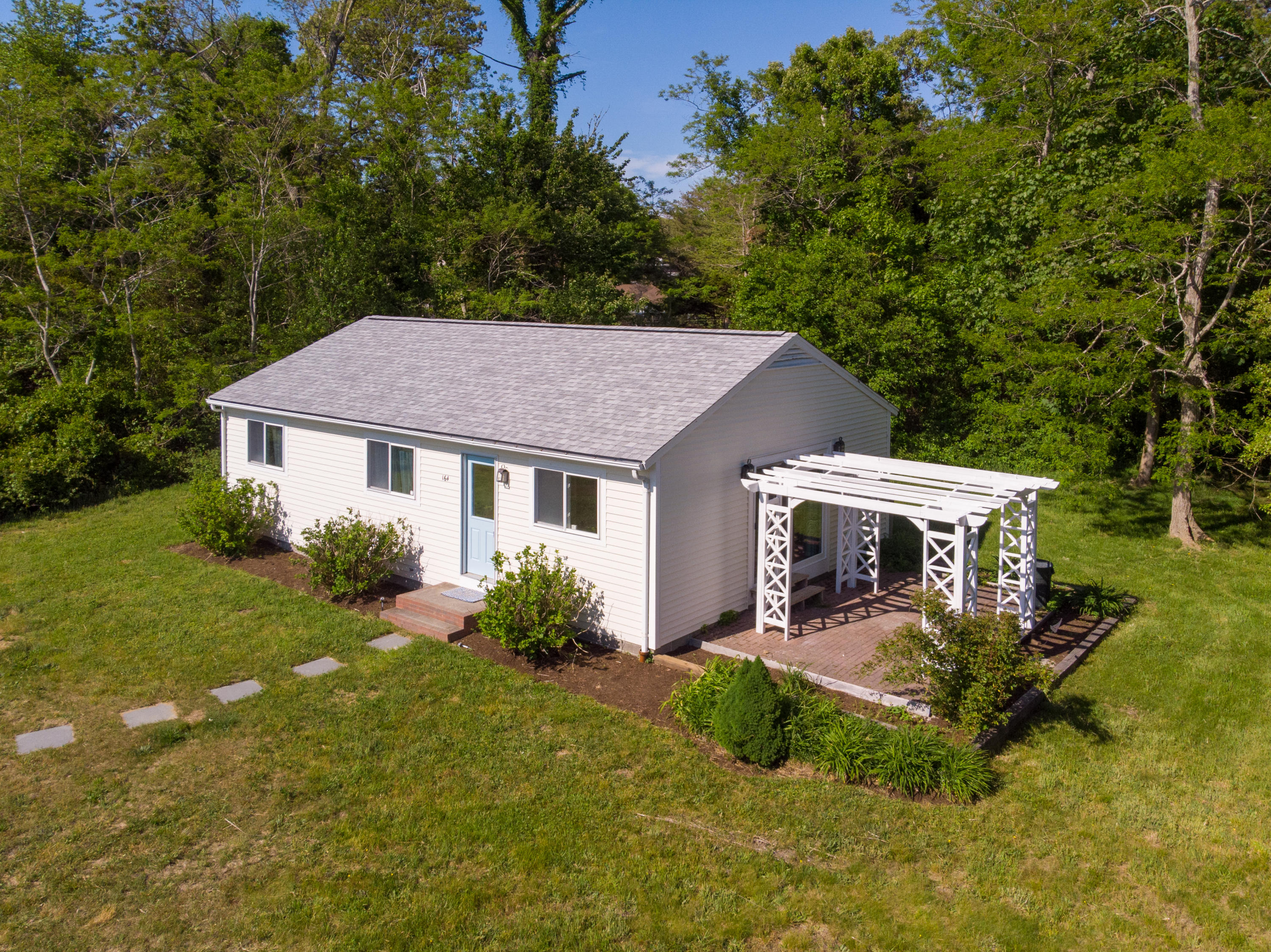 164 Breakwater Road Brewster, MA 02631 - Photo 46 of 57 a aerial view of a house with porch yard basket ball court and trampoline