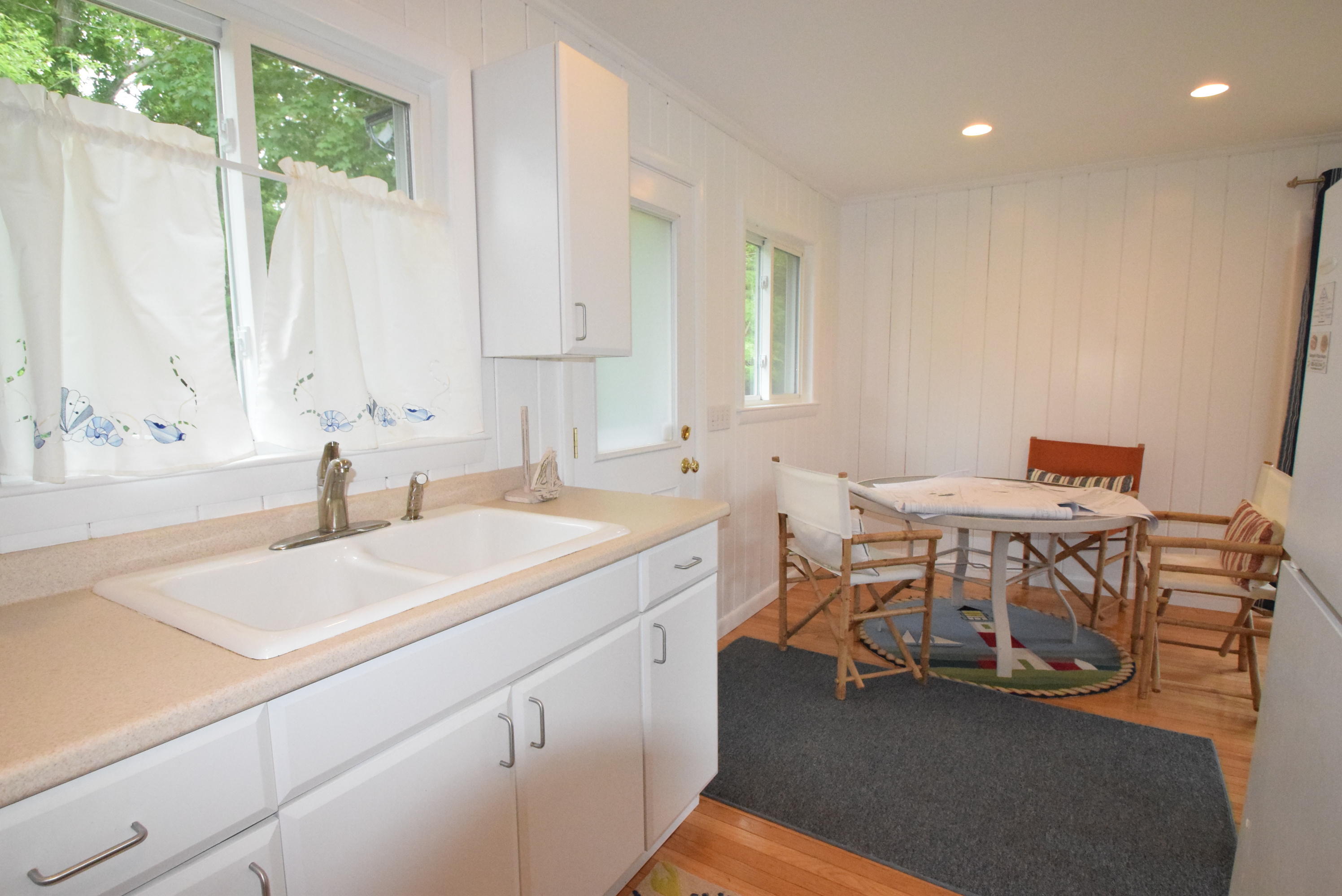 164 Breakwater Road Brewster, MA 02631 - Photo 47 of 57 a room with a table chairs and a sink