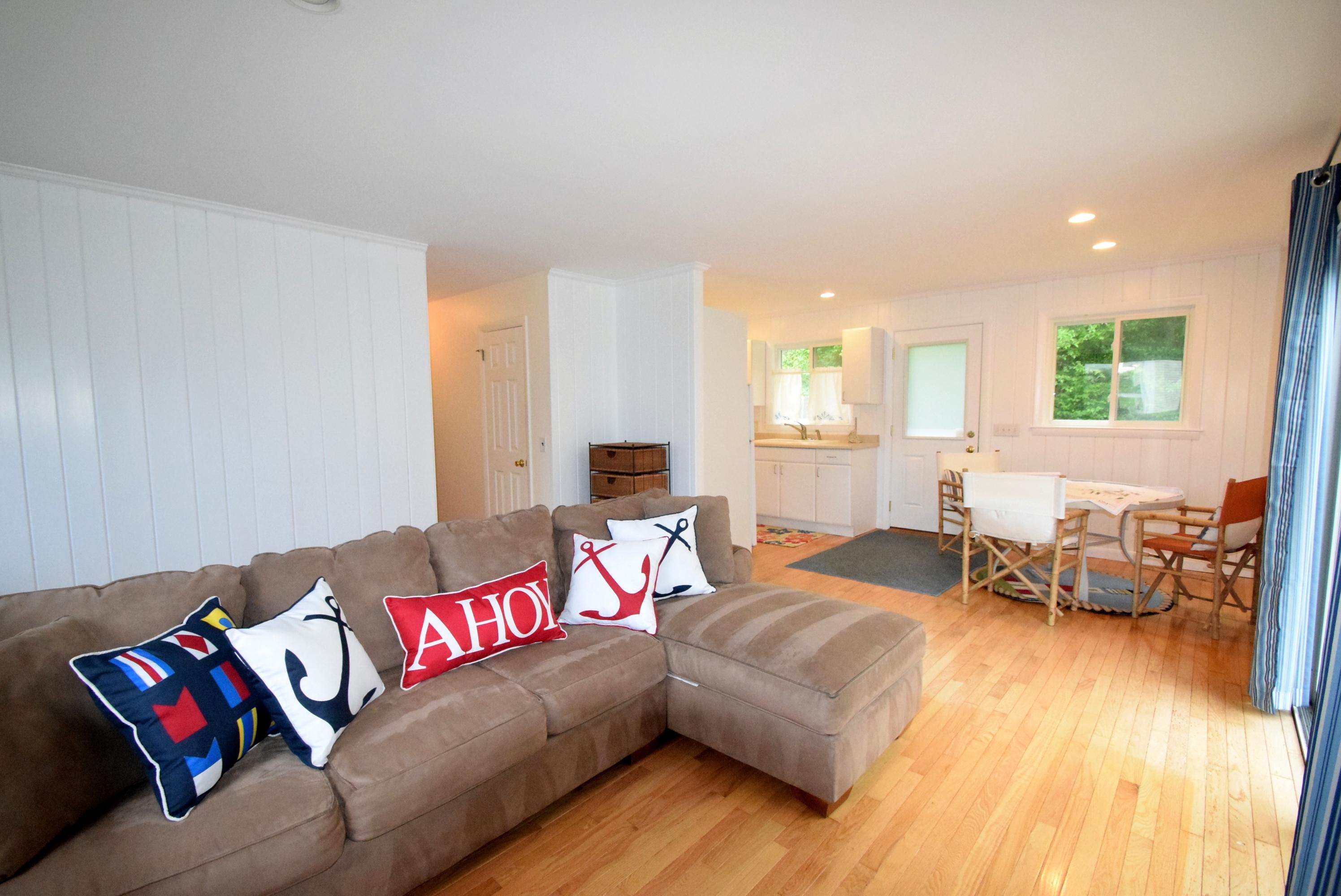 164 Breakwater Road Brewster, MA 02631 - Photo 49 of 57 a living room with furniture and a wooden floor