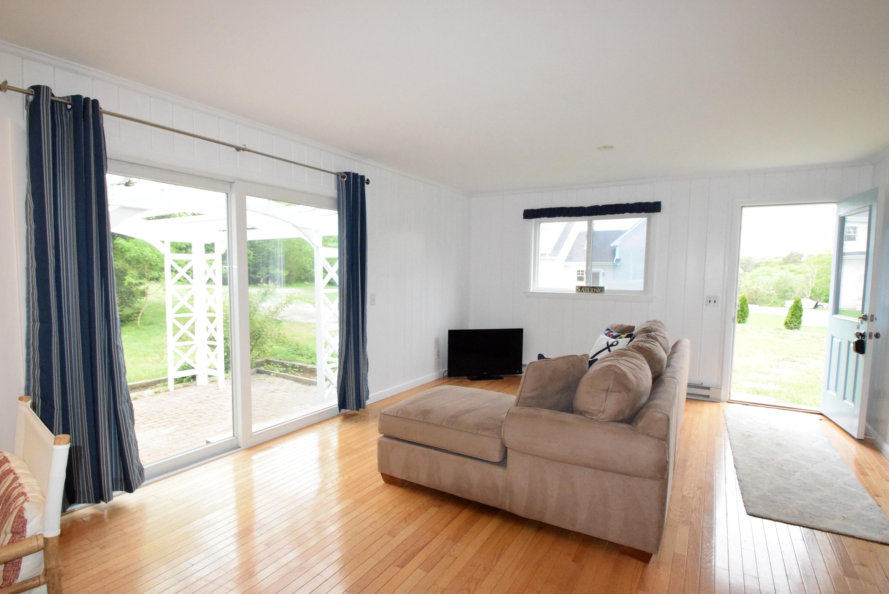 164 Breakwater Road Brewster, MA 02631 - Photo 50 of 57 a living room with furniture and a large window