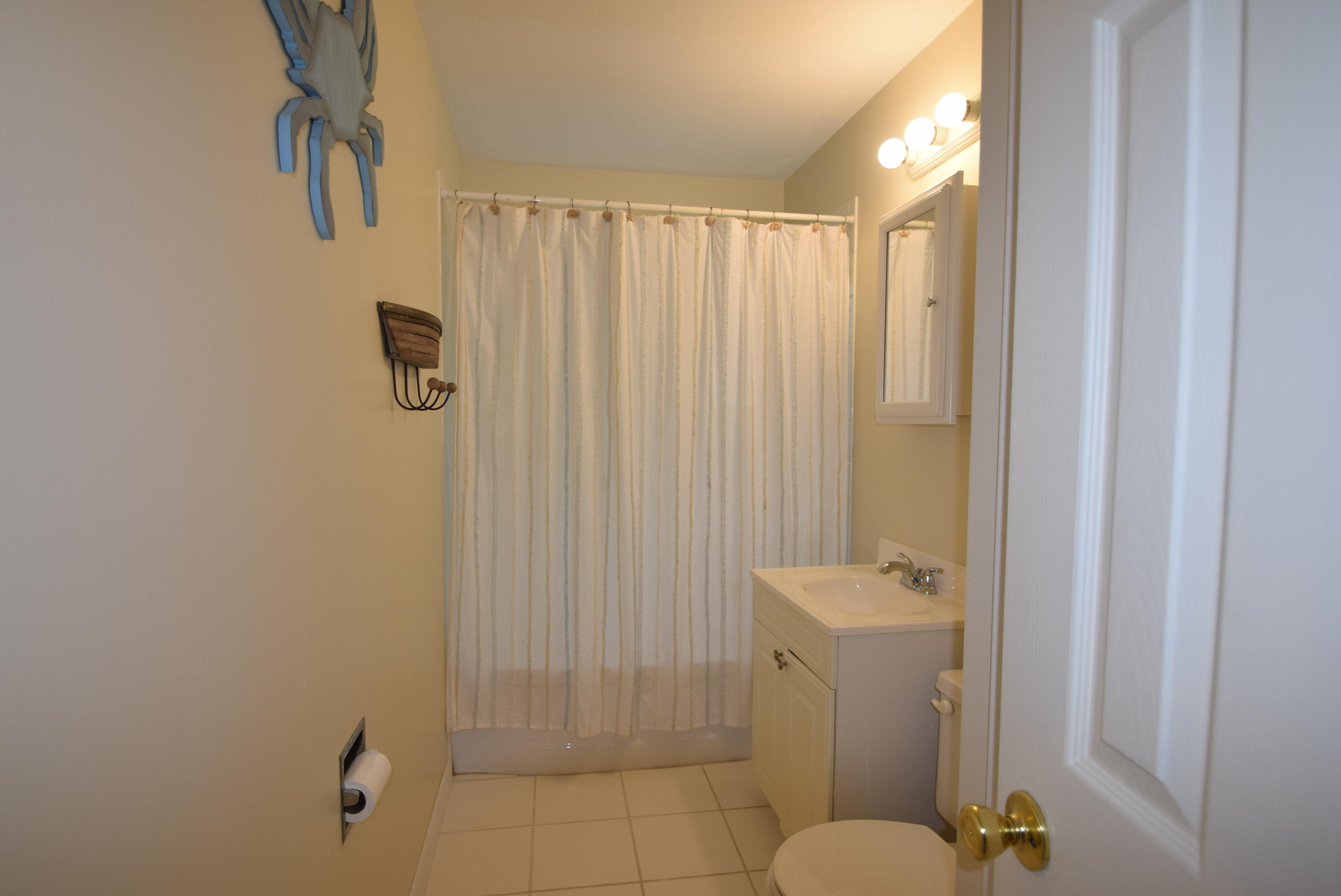 164 Breakwater Road Brewster, MA 02631 - Photo 53 of 57 a bathroom with a shower curtain