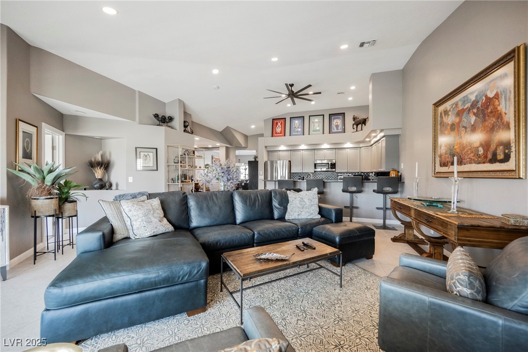 7625 Rolling View Drive, Unit 202 Las Vegas, NV 89149 - Photo 11 of 28 Living area with recessed lighting, ceiling fan, and high vaulted ceiling