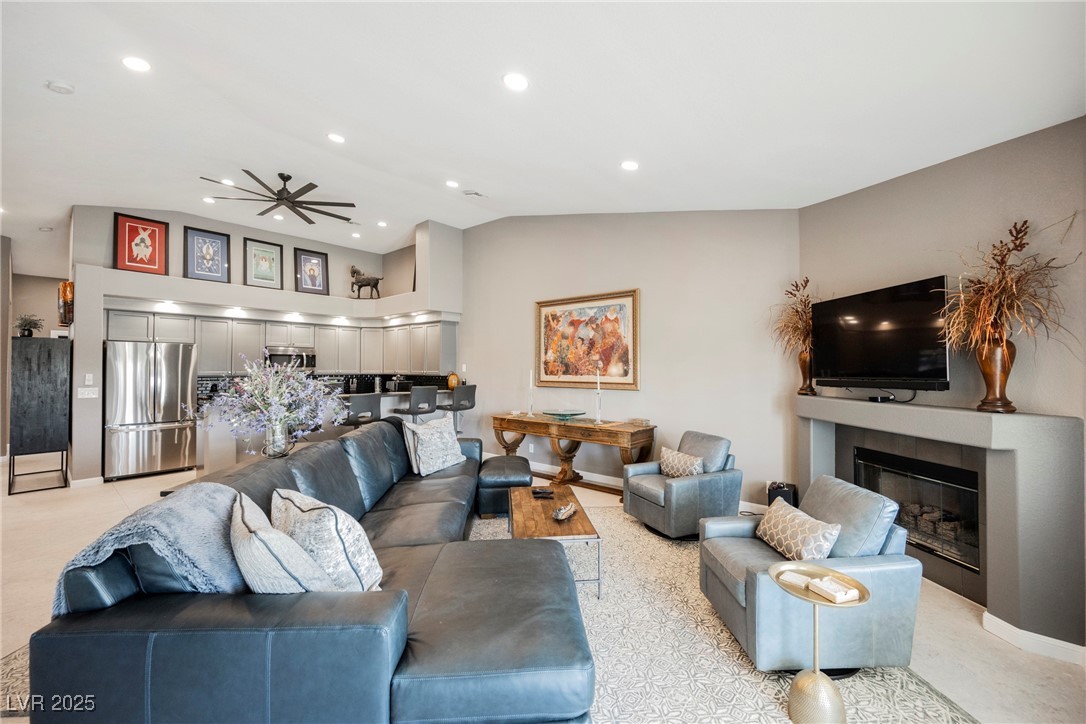 7625 Rolling View Drive, Unit 202 Las Vegas, NV 89149 - Photo 14 of 28 Living area featuring recessed lighting, a ceiling fan, a glass covered fireplace, light colored carpet, and high vaulted ceiling