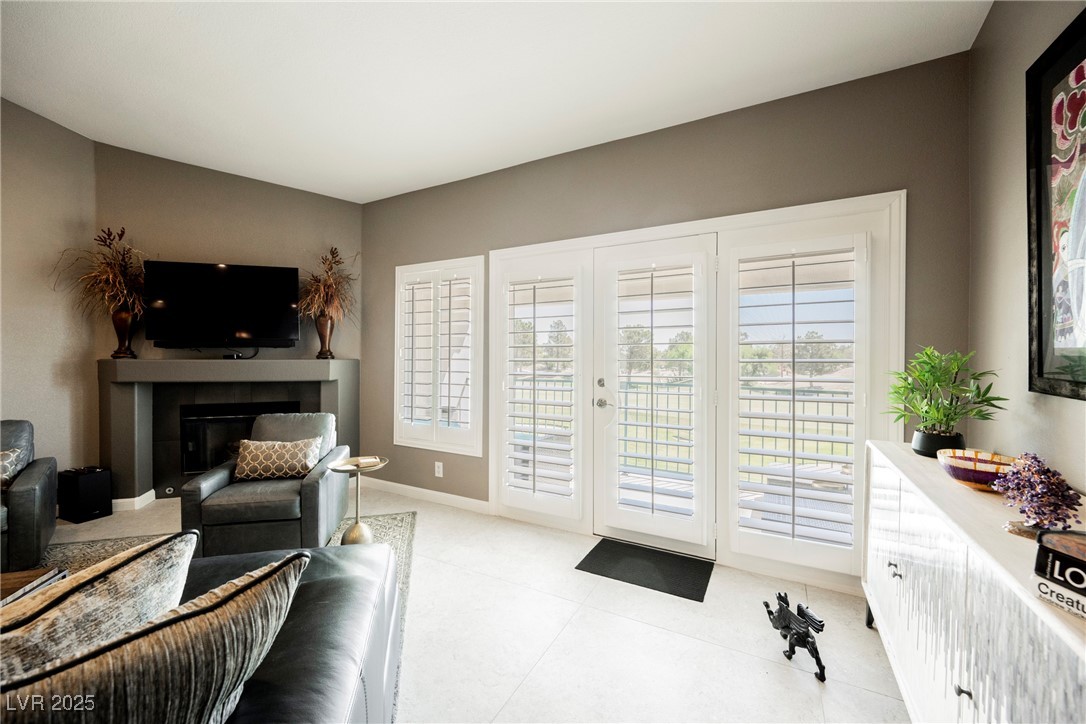 7625 Rolling View Drive, Unit 202 Las Vegas, NV 89149 - Photo 15 of 28 Living area featuring a glass covered fireplace and baseboards