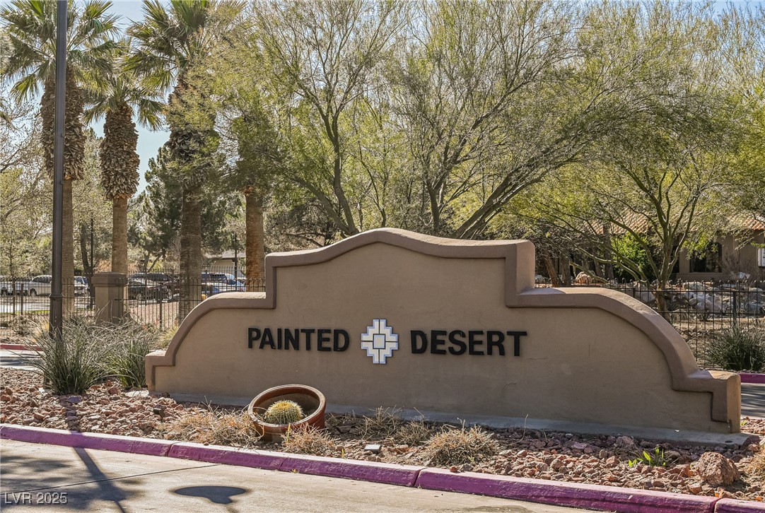 7625 Rolling View Drive, Unit 202 Las Vegas, NV 89149 - Photo 23 of 28 Community sign featuring view of wooded area
