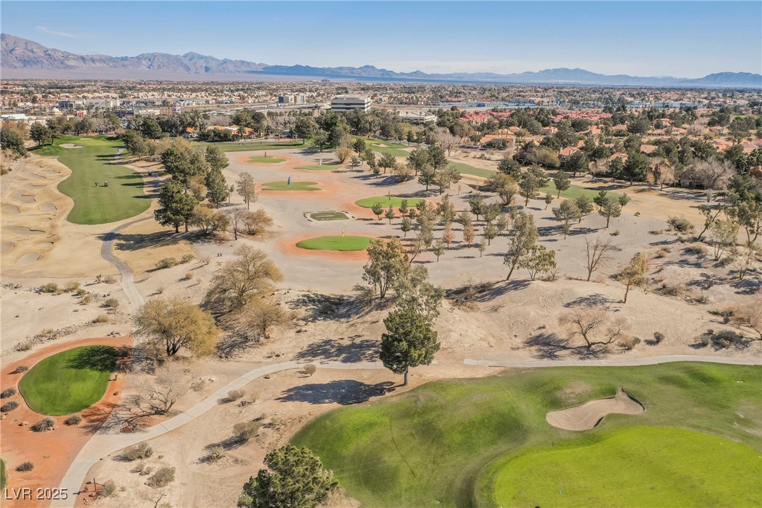 7625 Rolling View Drive, Unit 202 Las Vegas, NV 89149 - Photo 25 of 28 Aerial view of property and surrounding area featuring a mountainous background and a local golf course