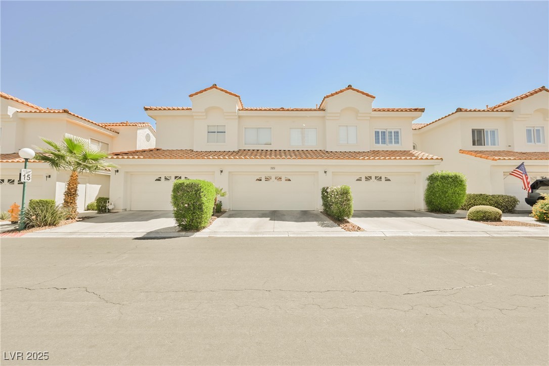 7625 Rolling View Drive, Unit 202 Las Vegas, NV 89149 - Photo 26 of 28 Mediterranean / spanish-style house featuring concrete driveway, stucco siding, and a tile roof