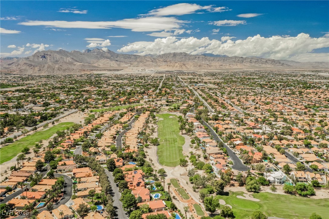 7625 Rolling View Drive, Unit 202 Las Vegas, NV 89149 - Photo 27 of 28 Aerial perspective of suburban area with a golf club and a mountain backdrop