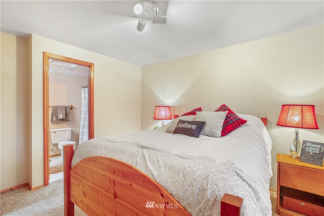 22412 15th Place West Bothell, WA 98021 - Photo 14 of 25 a bedroom with a bed and a chandelier